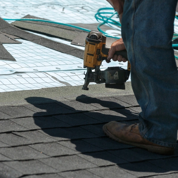 Image showing the application of starter shingles on a roof edge.