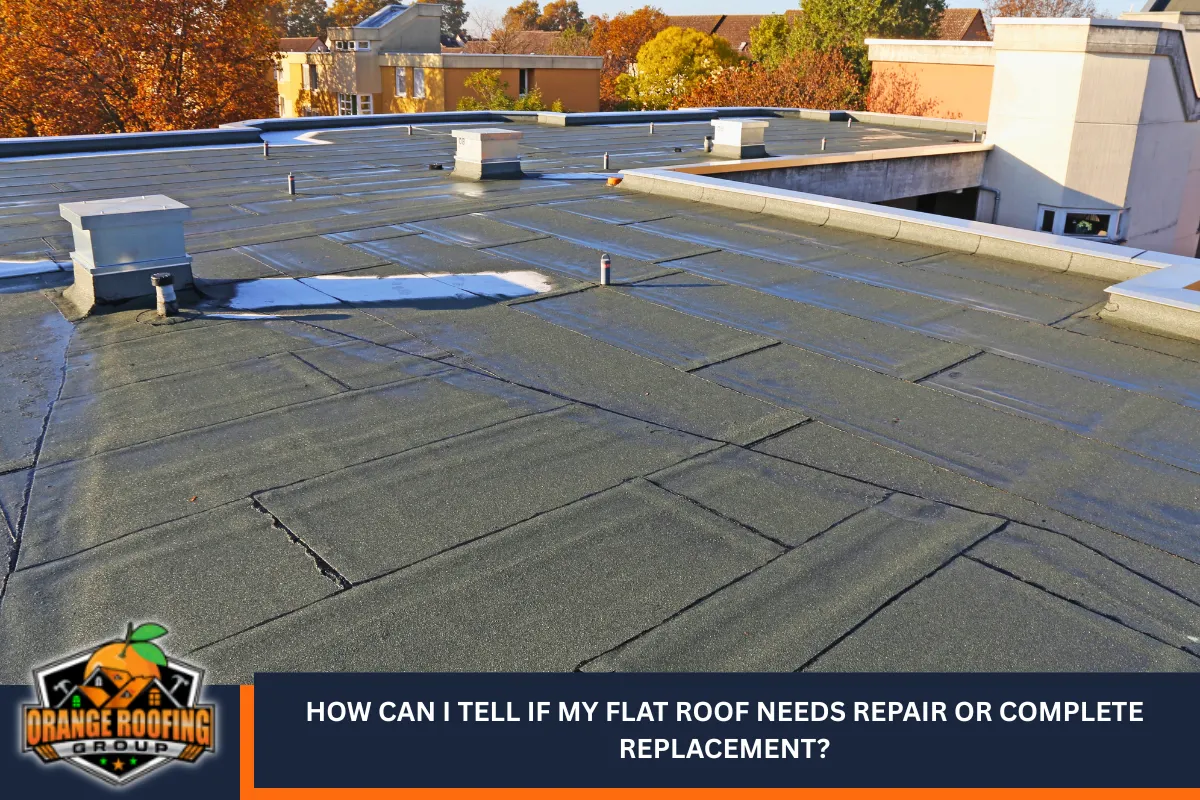 How can I tell if my flat roof needs repair or complete replacement?